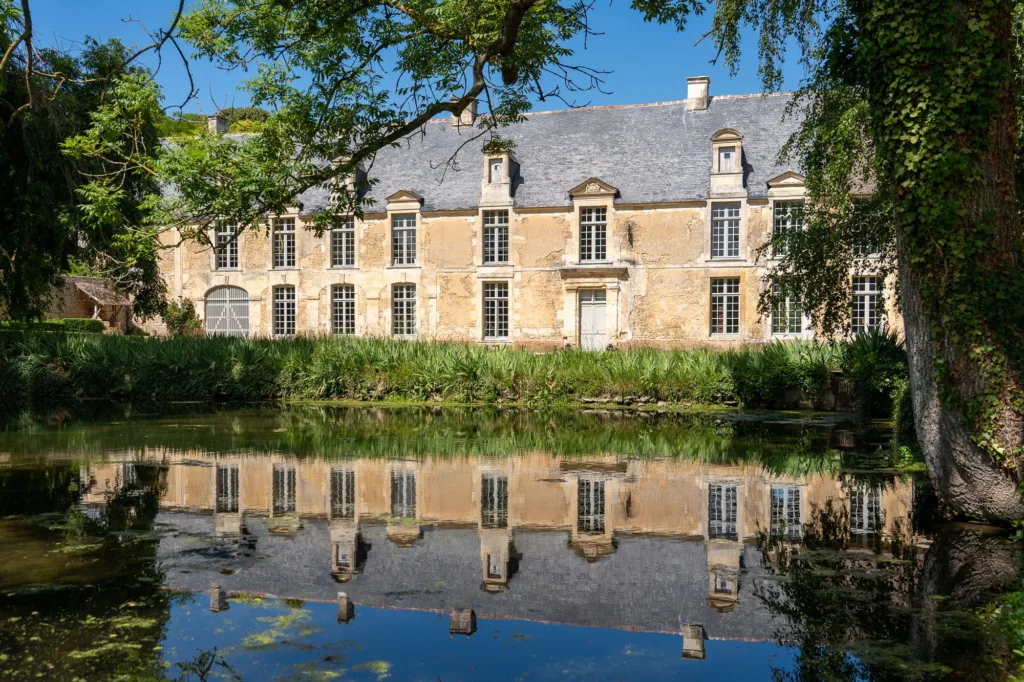 Norman château reflected in a pond for corporate retreats